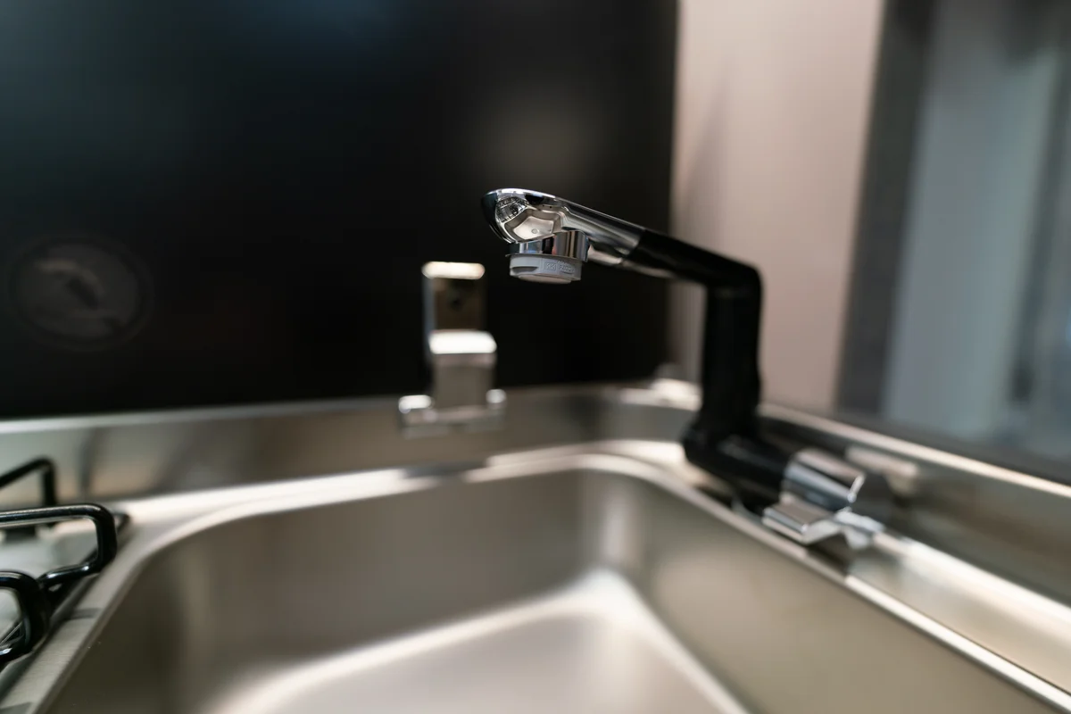 Edler Wasserhahn an Alu-Spüle in der Küche für kleine Wohnwagen